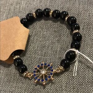 Elegant Black and Gold Bracelet with Ornate Charm